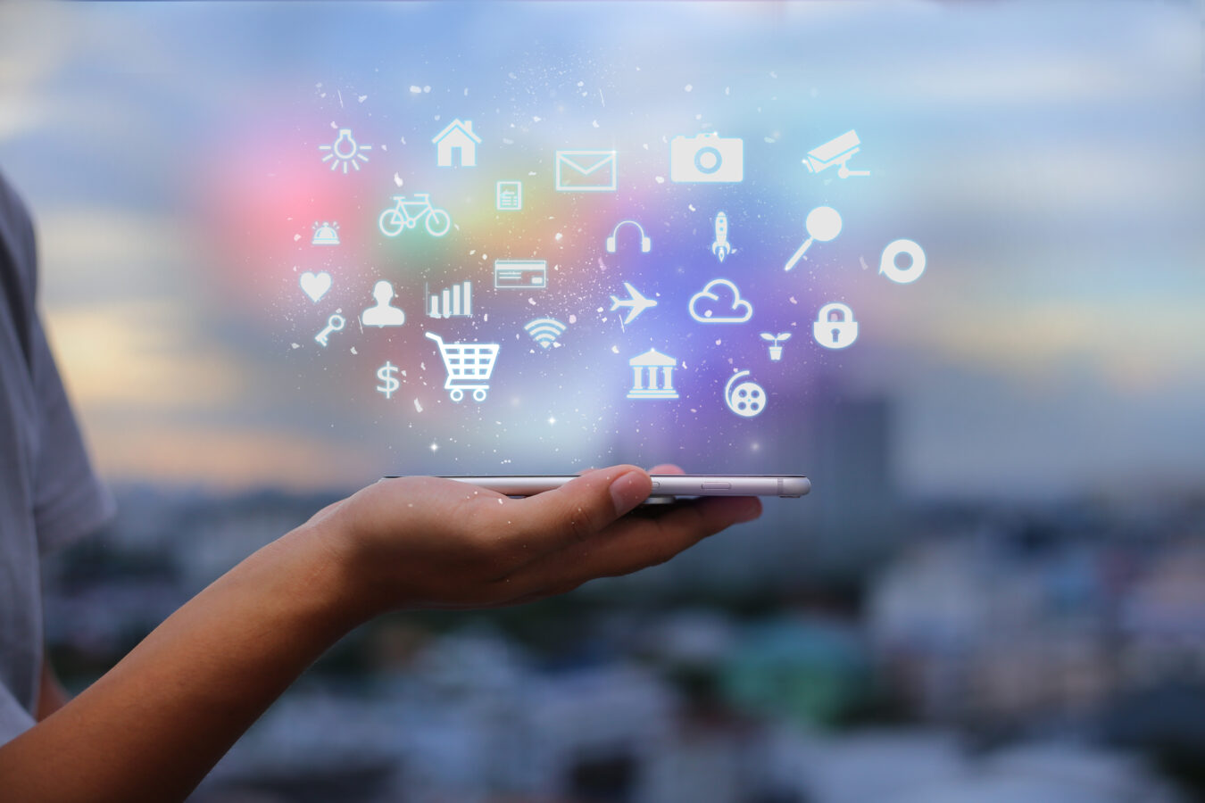 A hand holding out a phone with apps that enhance brand loyalty