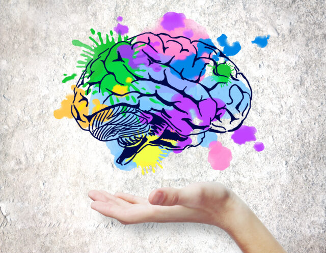 A hand holds a brain sketch representing the Ei Evolution Summit.