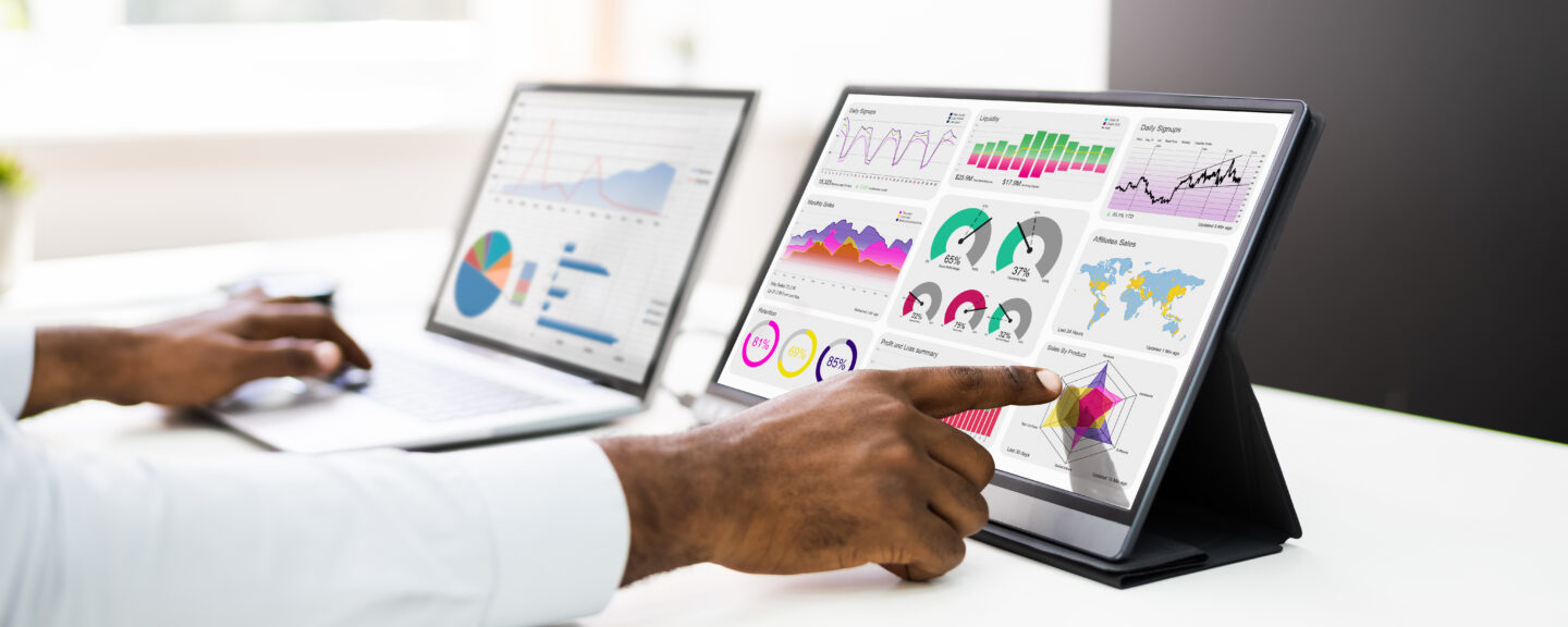 A businessman starting small with big data by selecting points from the analytics on his tablet.