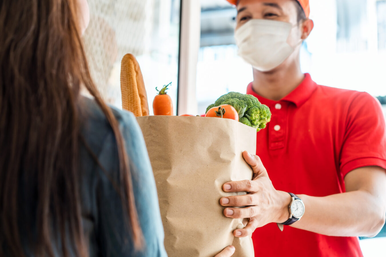 A man perform last-mile delivery of a food package.
