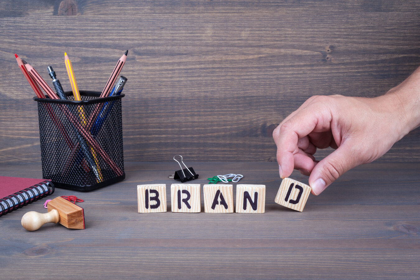 A photo shows wooden blocks formed in order to represent the brand value chain stages.