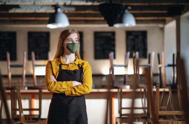 an image showing a restaurant worker thinking about the future of the restaurant industry.