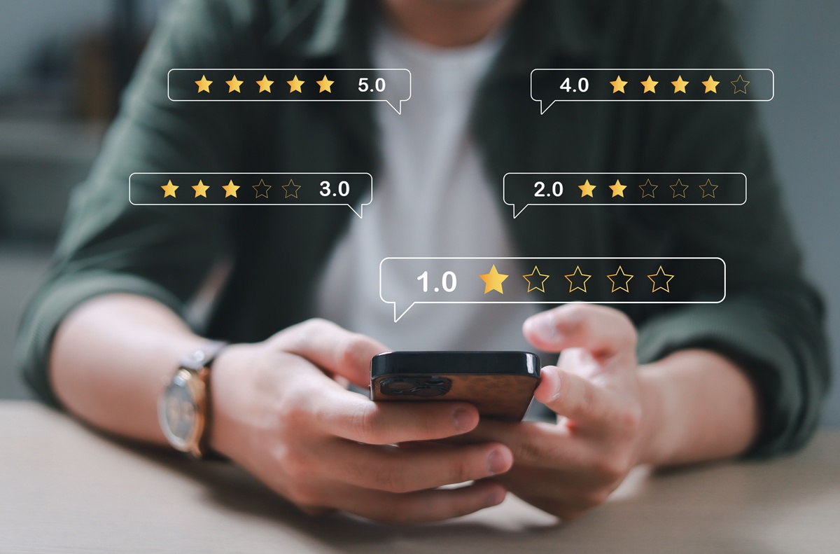 Person using a phone and leaving reviews.