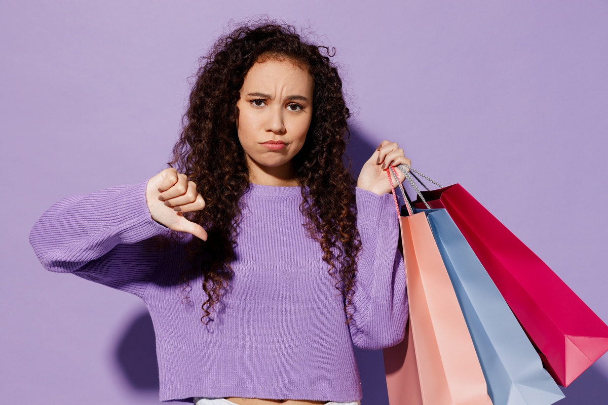 The image shows a woman who is unhappy with her shopping.